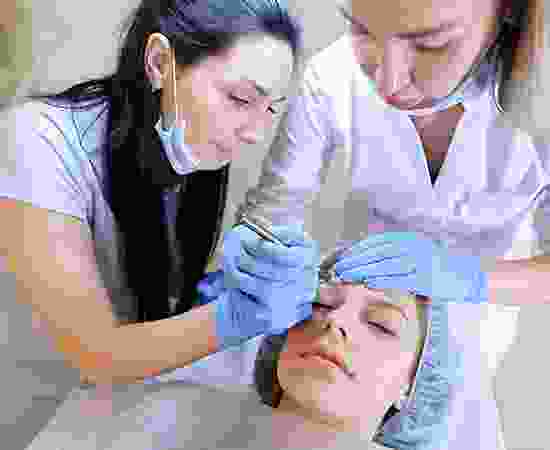 blog-detail-3 A woman getting her face waxed by two other women.